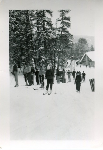 1950s Skiers on tow rope with lodge in back