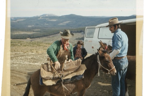 1974 Film Crew at Showdown cowboys loading up gear with kid helping