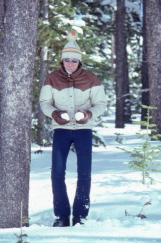 1974 unknown guy with snowballs and smilling near trees