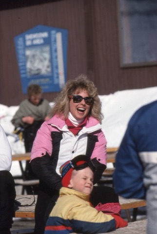 1980s unknown woman laughing on deck with kid