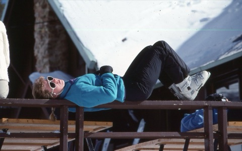 1989 Pam Gold sunbathing on deck railing