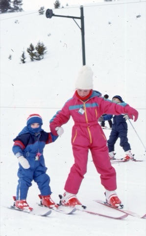 1989 Unknown kid helping smaller kid in learning area