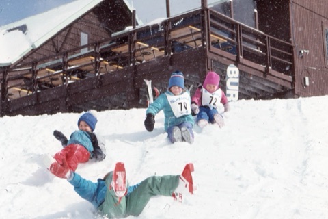 1990s Kings sliding down hill near lodge