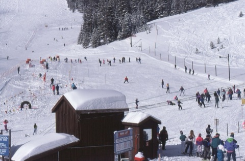 1990s Learning area on busy sunny day the building is the Poma Lift