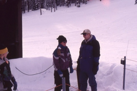 1990s Lift operator Poma lift with instructor smiling