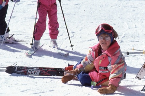 1990s Marti Pugh-Alltucker on the ground looking at camera