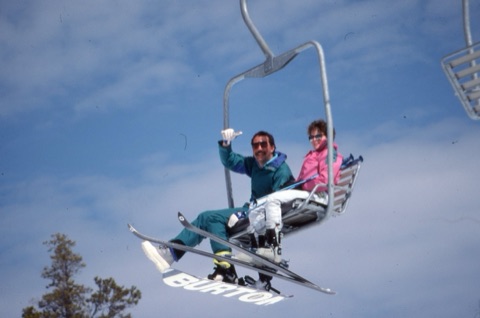 1990s Scott Mosher with snowboard and unknown female skier on chairlift
