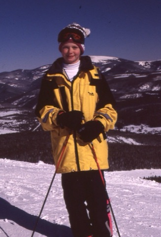 1990s unknown kid on top of mountain in yellow coat