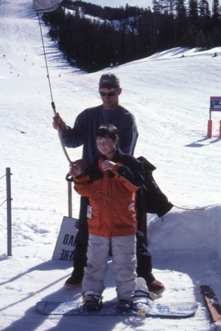 1990s unknown lift operator and kid on Poma Lift