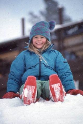 1990s unknown little girl on the snow near lodge