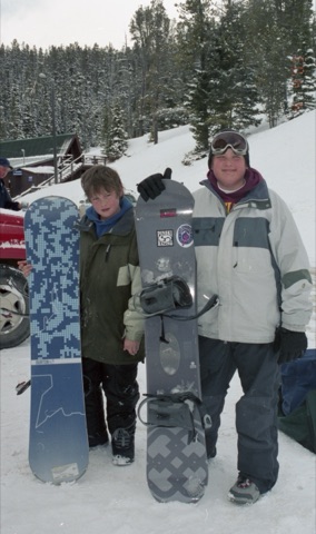 2000s Jared Burton and Eric Hoxter with snowbaords near lodge