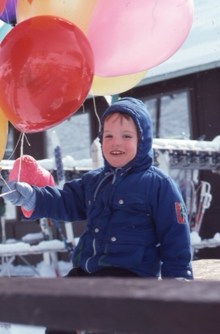 1990s unknown small boy with baloons on deck