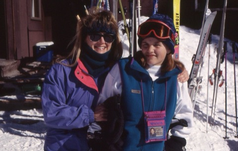 1990s unknown woman and girl with skis in background