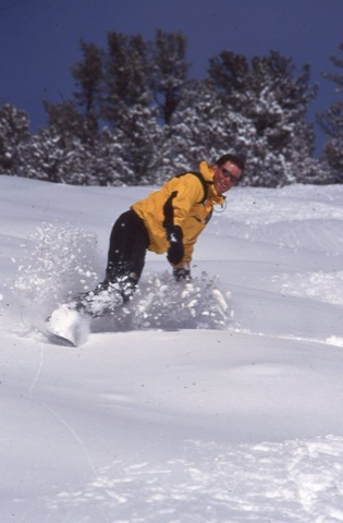 1990s unknownsnowboarder smiling with no hat on