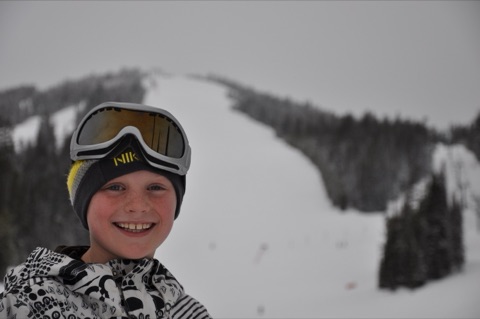 2009 Bridger Boedecker smiling at lodge with mountain in back