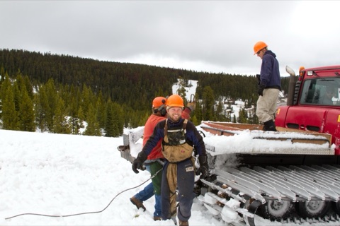 2011 Ben Haugan, Jamie Gregory near snowcat hauling logs
