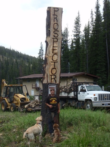 2013 Ben Haugan chain saw carving sign out of tree of Prospector double chairlift-after