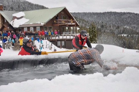 2019 Mel Carnahan — Outside the lodge — Ski Patrol fishing a pond skimmer out of the water Facebook Post from 04-14-2019
