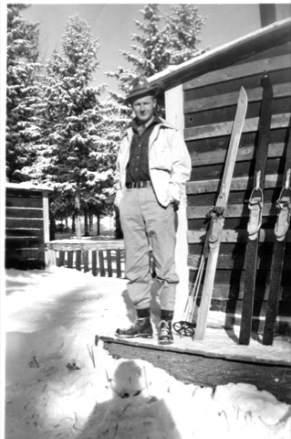 1941 Man standing in front of building with skiis - Donated by Donna Wahlberg