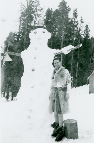 1951 Jack Throckmorton — Wearing hula attire next to a giant snowman