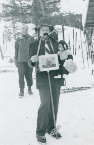 1951 Kid dressed up with mustache and monkey near lodge