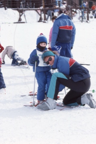 1989 Instructor helping kid and smiling - Frank Ball Photo