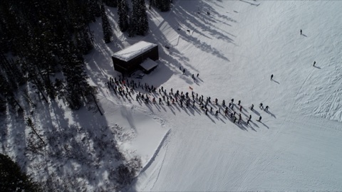 Triple chair lift line looking down