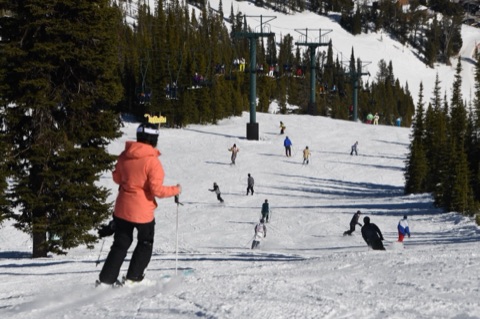 2021 On the Mountain — Skiers and snowboarders enjoying the snow, and a full lift