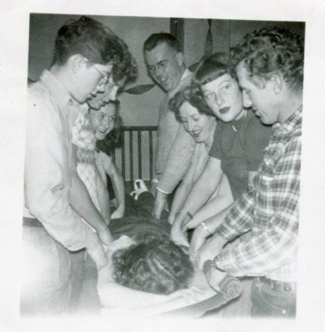 1940 Group helping injured woman