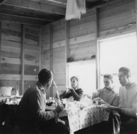 1940s A meal inside an unfinished timber building