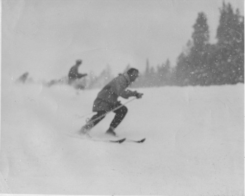 1940s A skier crouched in heavy snow