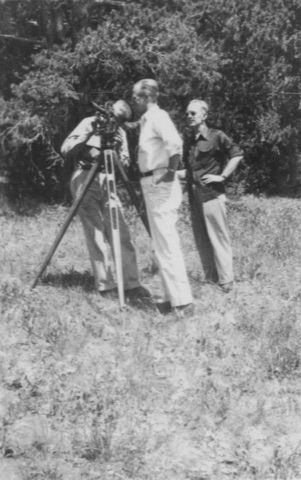1940s Three men with a surveyor's transit