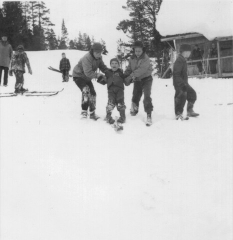 1940s Two boys holding up a small child