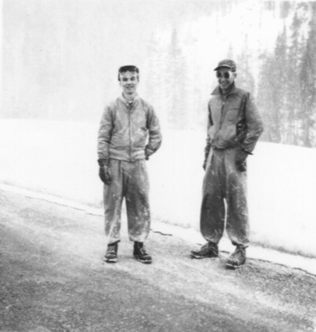 1940s-50s Two young men by a road in falling snow