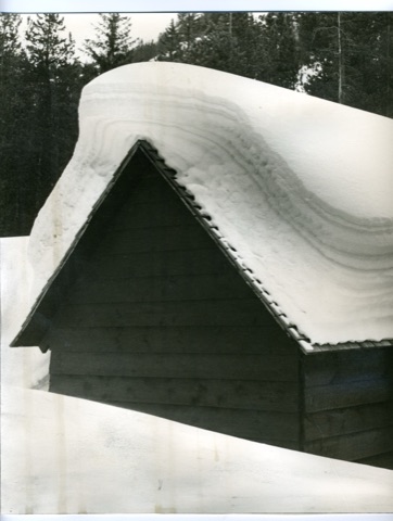 A cabin under a snow cornice